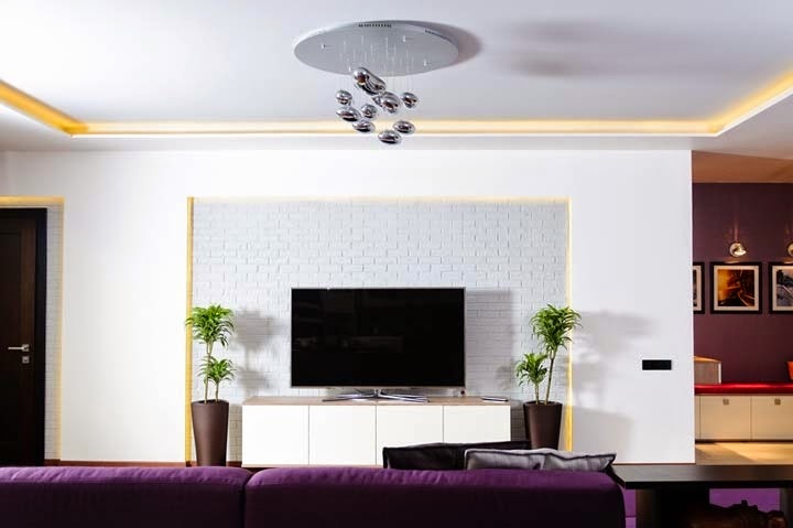 Apartment with purple shades - TV wall bricks